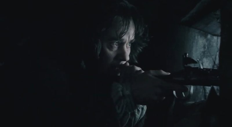 johnathan masbath aims his northwest trade gun from a porthole in his stand