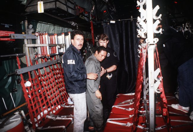 Manuel_Noriega_with_agents_from_the_U.S._DEA-scaled.jpg