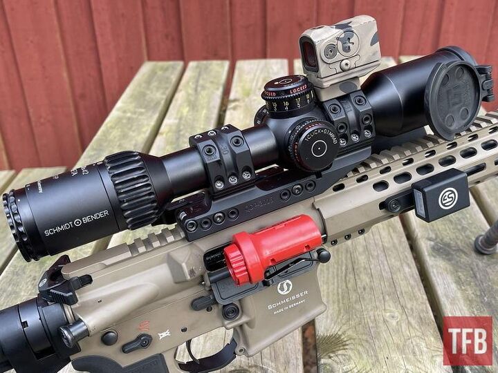 Schmeisser AR15 setup for DMR shooting, with a Schmidt & Bender 3-12x42 META (FFP) and an Aimpoint ACRO secondary. The red “thing” is a Riflekühl Barrel Cooler by MagnetoSpeed and the SG Pulse can be seen to the right.