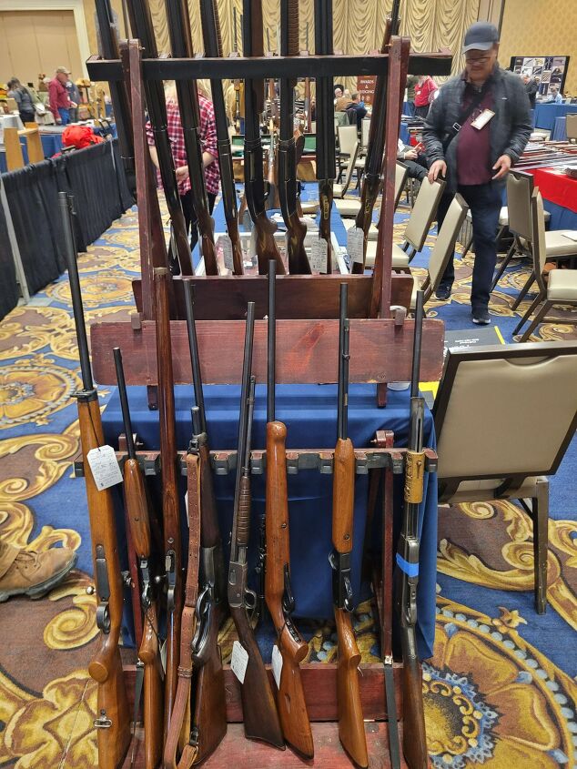 rimfires that deserve a reboot, At this gun show you can see a Remington Model 12 in the middle of the gun rack turned sideways I d be just as happy to see this or a Savage Model 29 come back maybe with slight changes to make manufacturing easier
